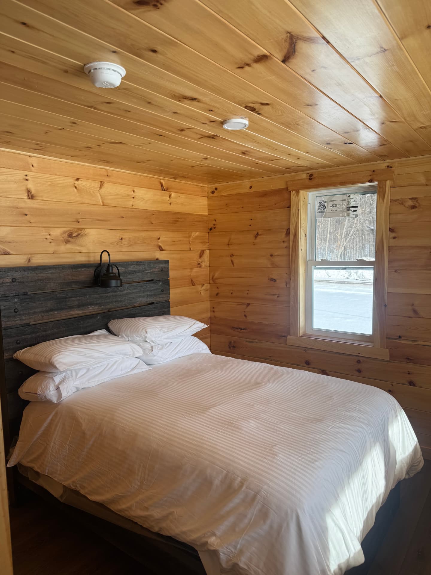 Wood-paneled cabin bedroom