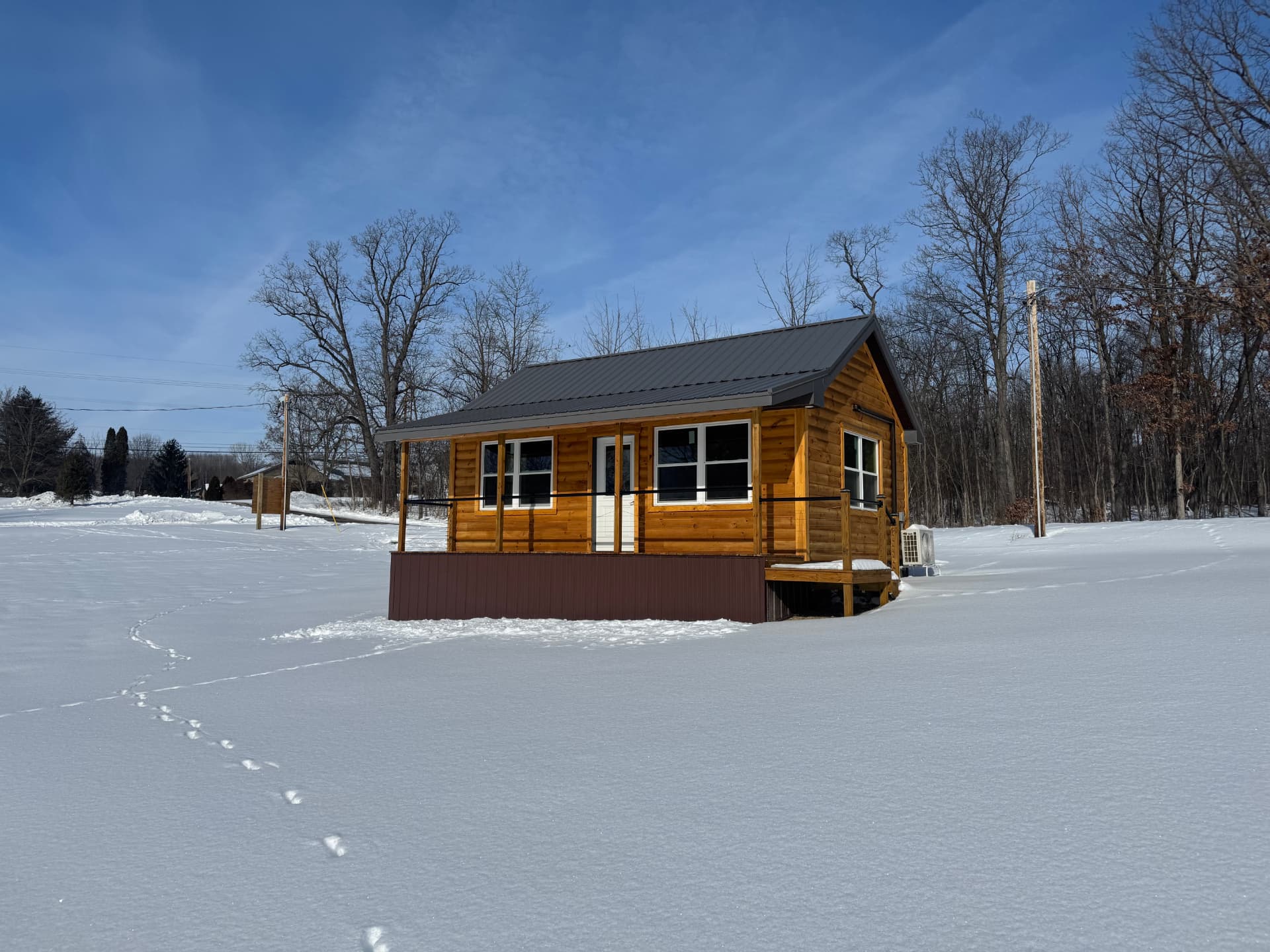 Wood cabin surrounded by snowy grounds